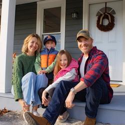 Movers Pete and Laura Schaffner with their family on their front porch.