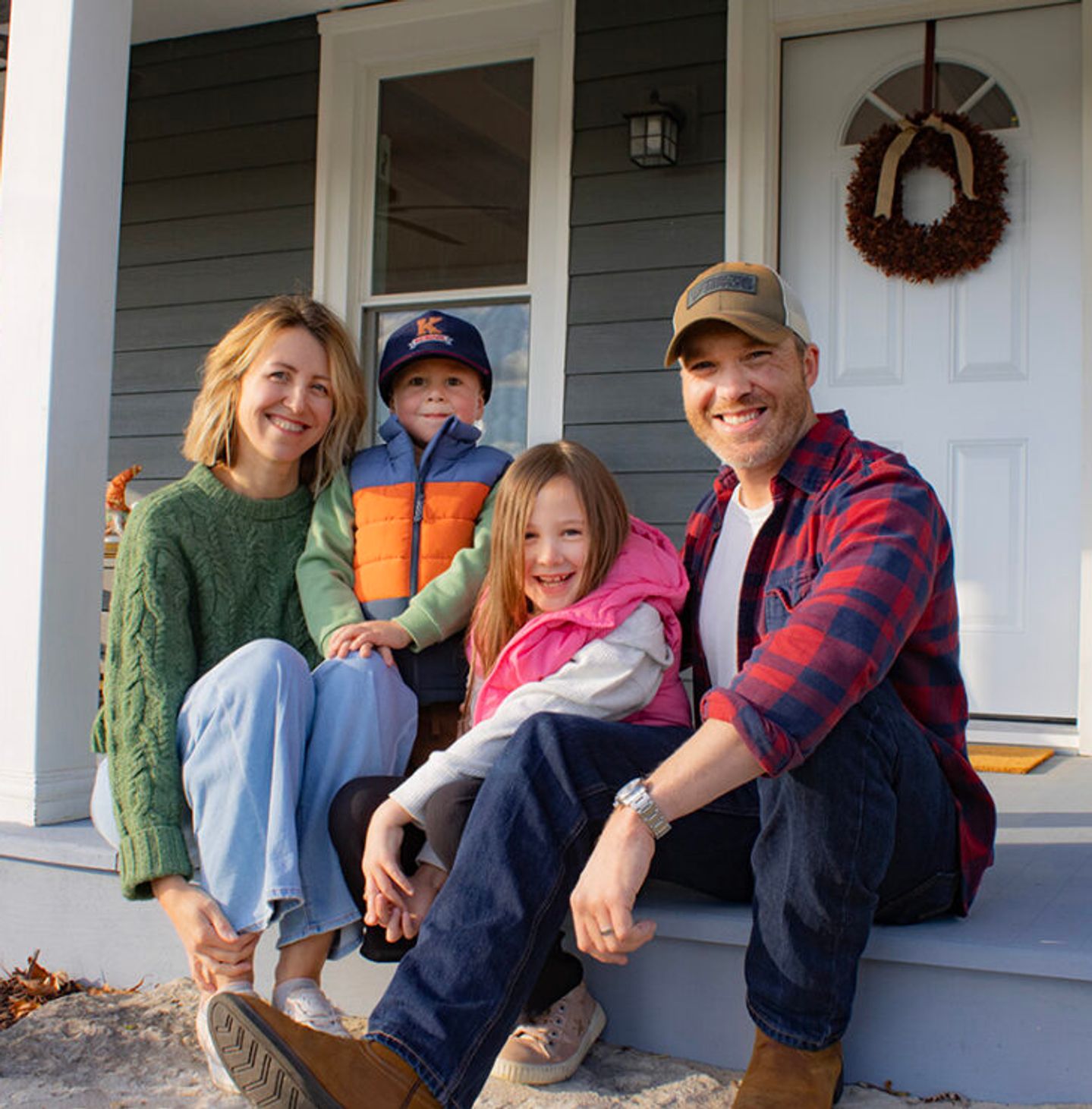 Movers Pete and Laura Schaffner with their family on their front porch.