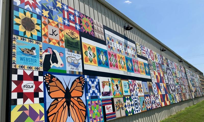 The Rooks County Arts Council mounted 295 barn quilts on the wall of the Stockton city utility building.