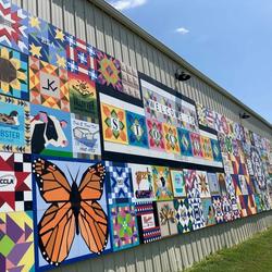 The Rooks County Arts Council mounted 295 barn quilts on the wall of the Stockton city utility building