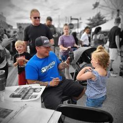 Cervantes Brothers (local artists) face painting at an event