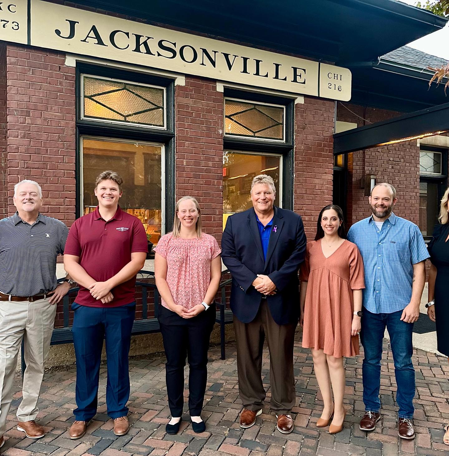Successful applicants to the first round of the Jacksonville Region’s MakeMyMove program gathered at Jacksonville Regional Economic Development Corporation’s Investor Appreciation Event. Pictured left to right: Lance, Cade, Emma, Jacksonville Mayor Andy Ezard, Elena, Nathan and JREDC President Kristin Jamison.