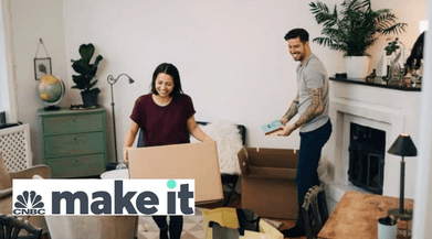 Getty Image. Man and woman unpacking moving boxes.