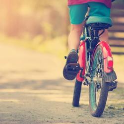 Child on a red bike