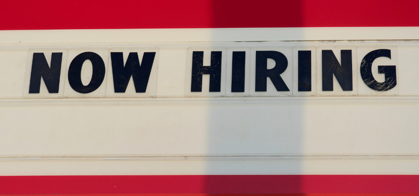 A Now Hiring sign with headline The Most Comprehensive List of Employers with Open Remote Jobs