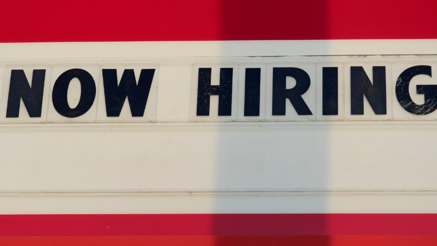 A Now Hiring sign with headline The Most Comprehensive List of Employers with Open Remote Jobs