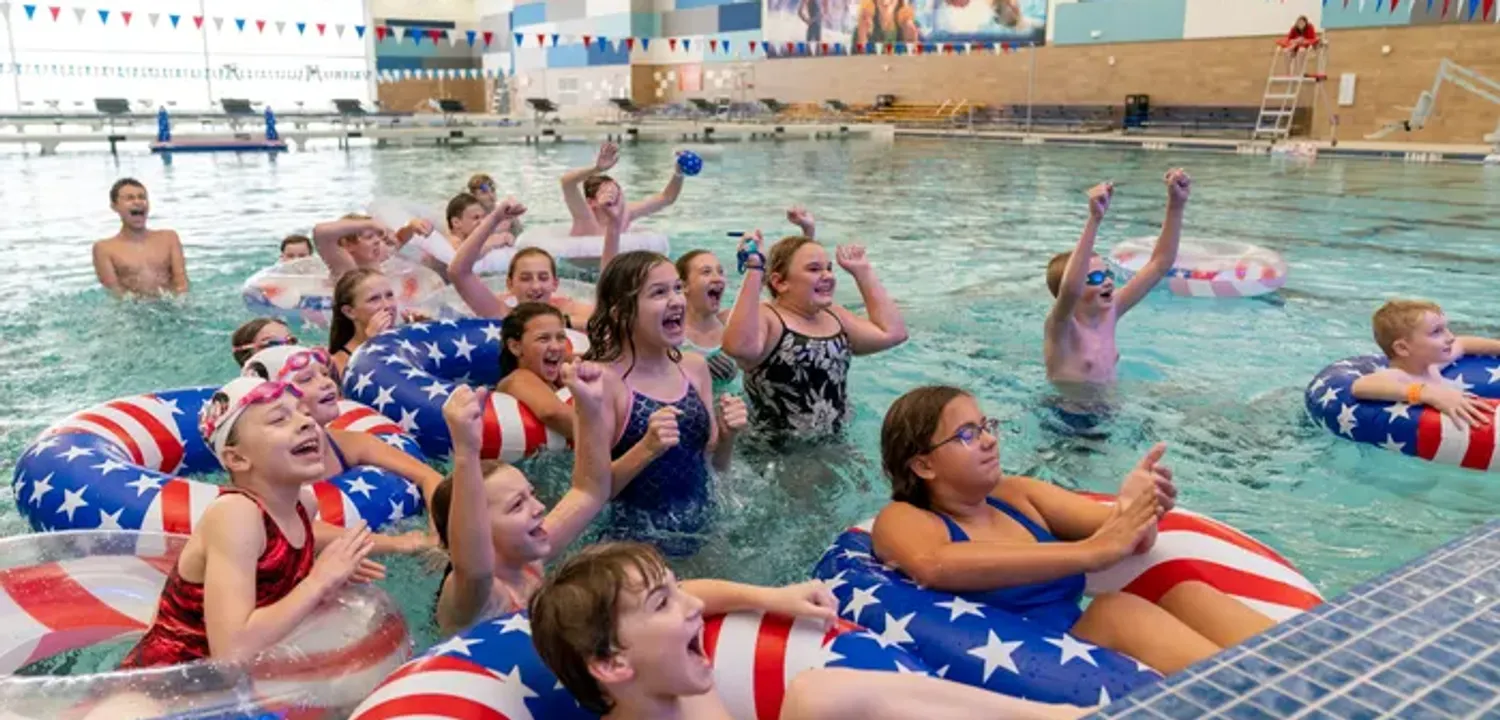 A group of young swimmers from Evansville watch Lilly King compete for gold