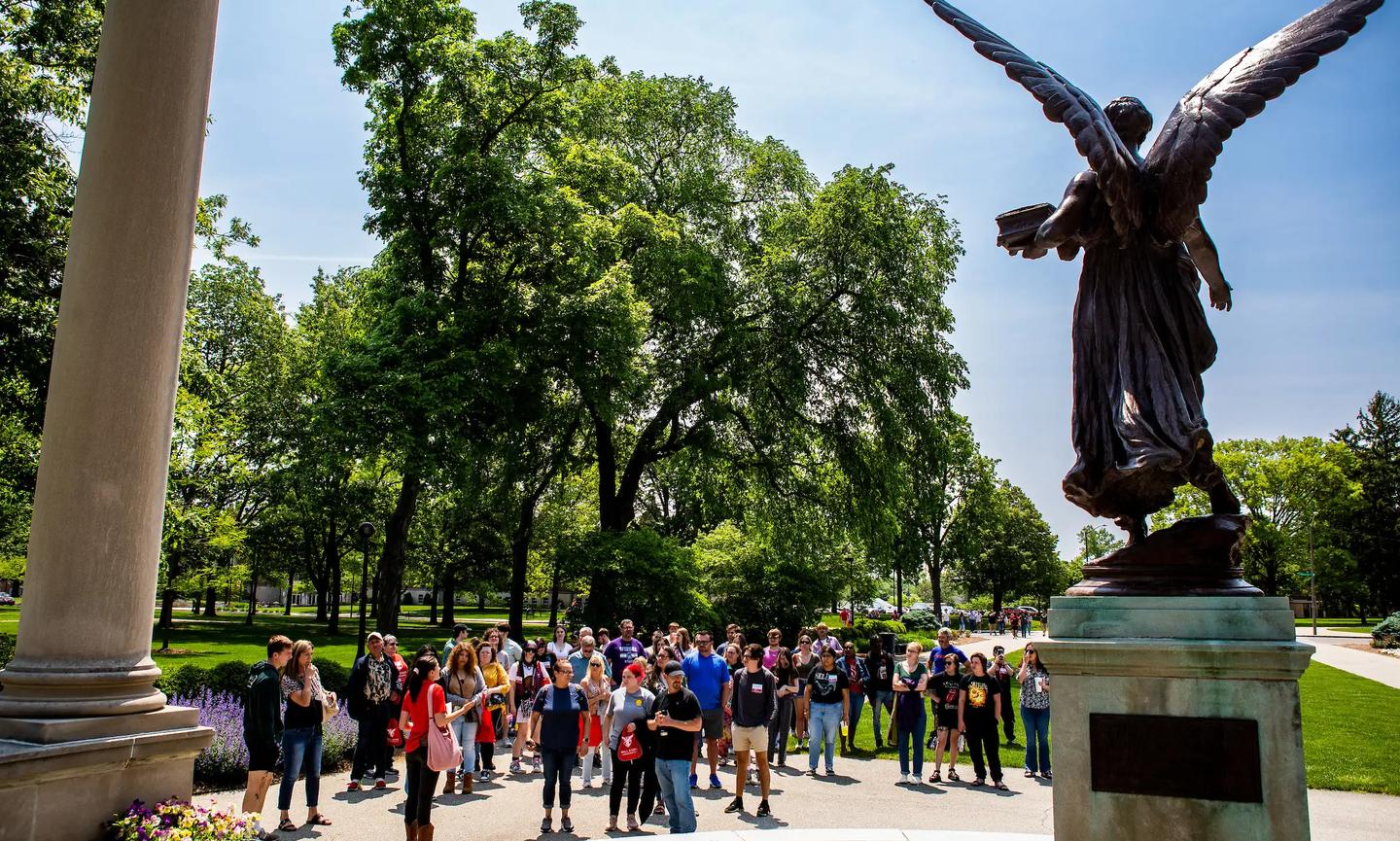 Group visiting Beneficence, or "Benny," on Ball State University's campus. (Photo credit: Ball State University)