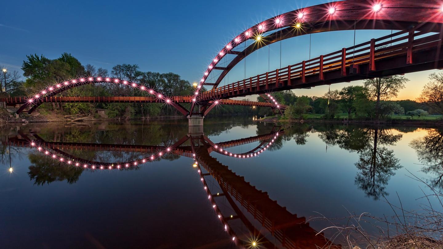 The Tridge at night, spans the confluence of the Chippewa and Tittabawassee Rivers in Chippewassee Park in Midland, Michigan