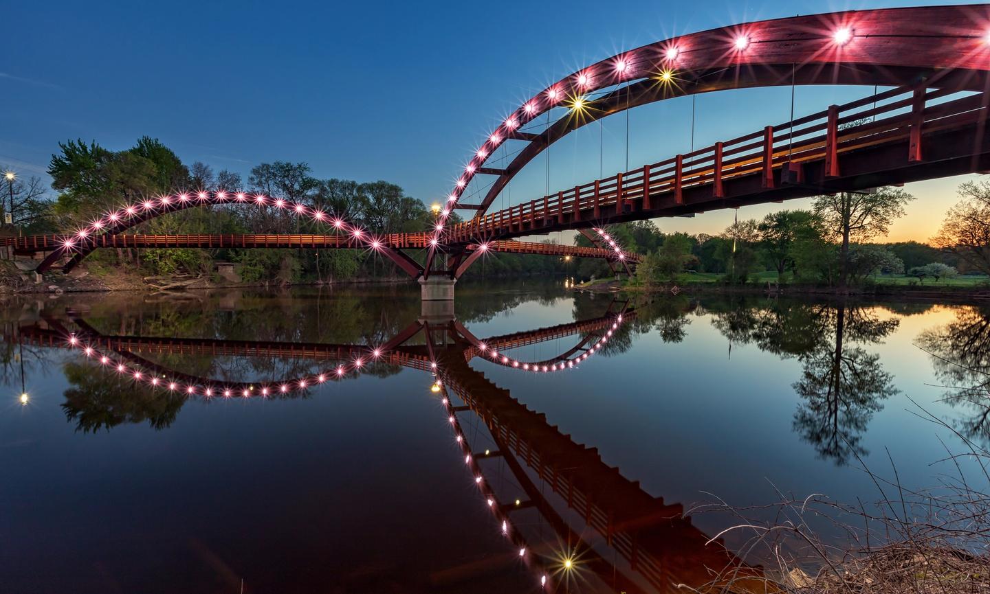 The Tridge at night, spans the confluence of the Chippewa and Tittabawassee Rivers in Chippewassee Park in Midland, Michigan