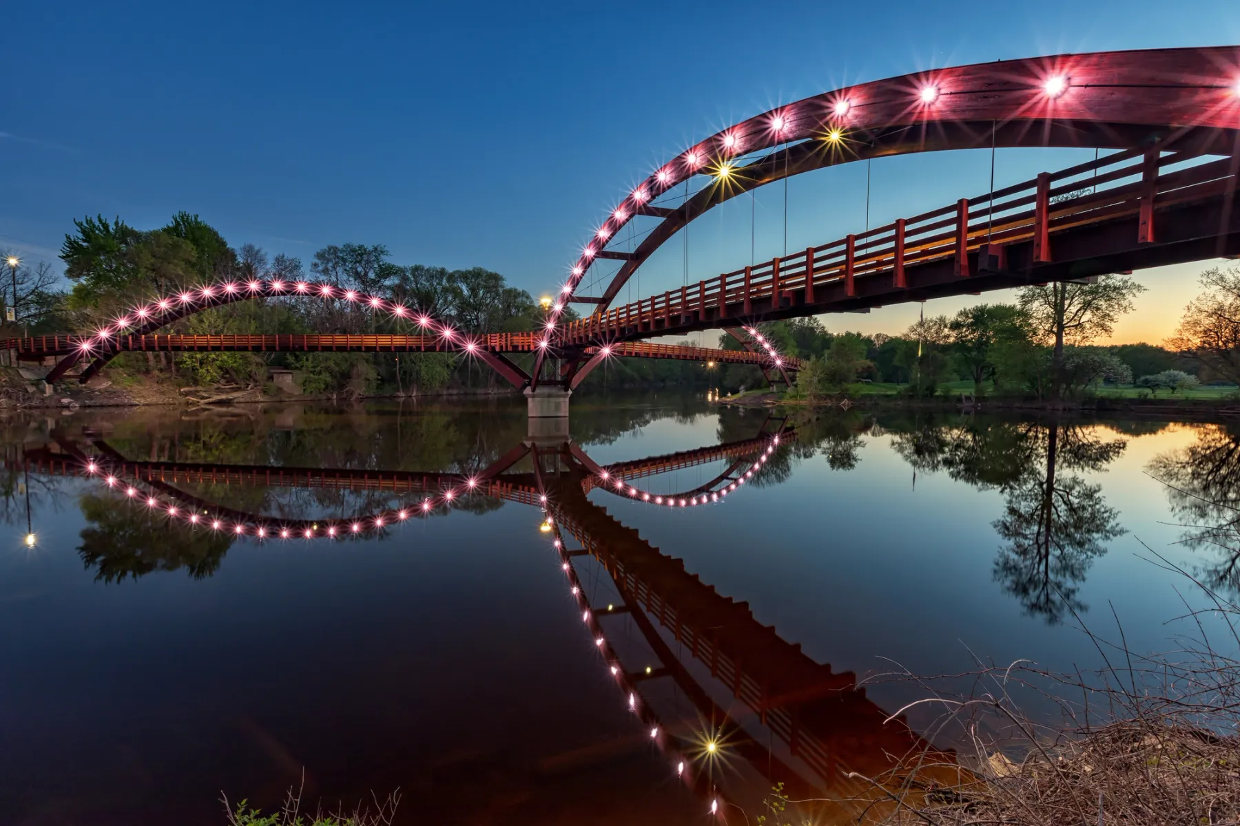 The Tridge at night, spans the confluence of the Chippewa and Tittabawassee Rivers in Chippewassee Park in Midland, Michigan