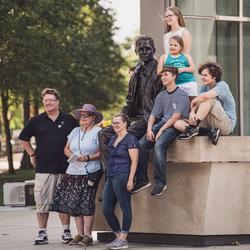 Family taking pictures on Purdue's campus