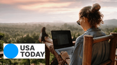 Woman sitting on porch working at laptop