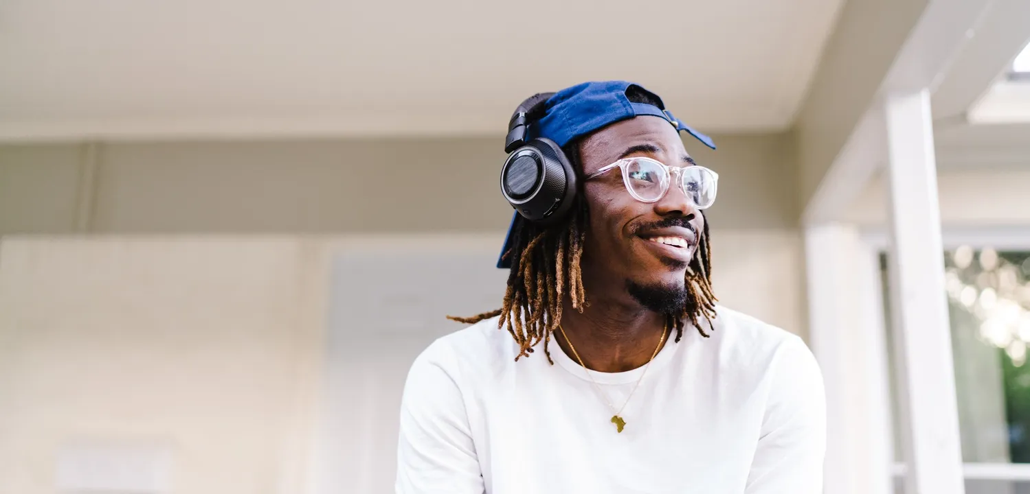 Man sits on porch with headset.