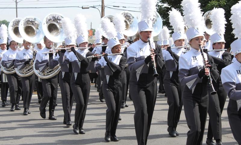 Local school children perform in the annual Rooster Day Parade. Photo credit: val lawless / Shutterstock.com