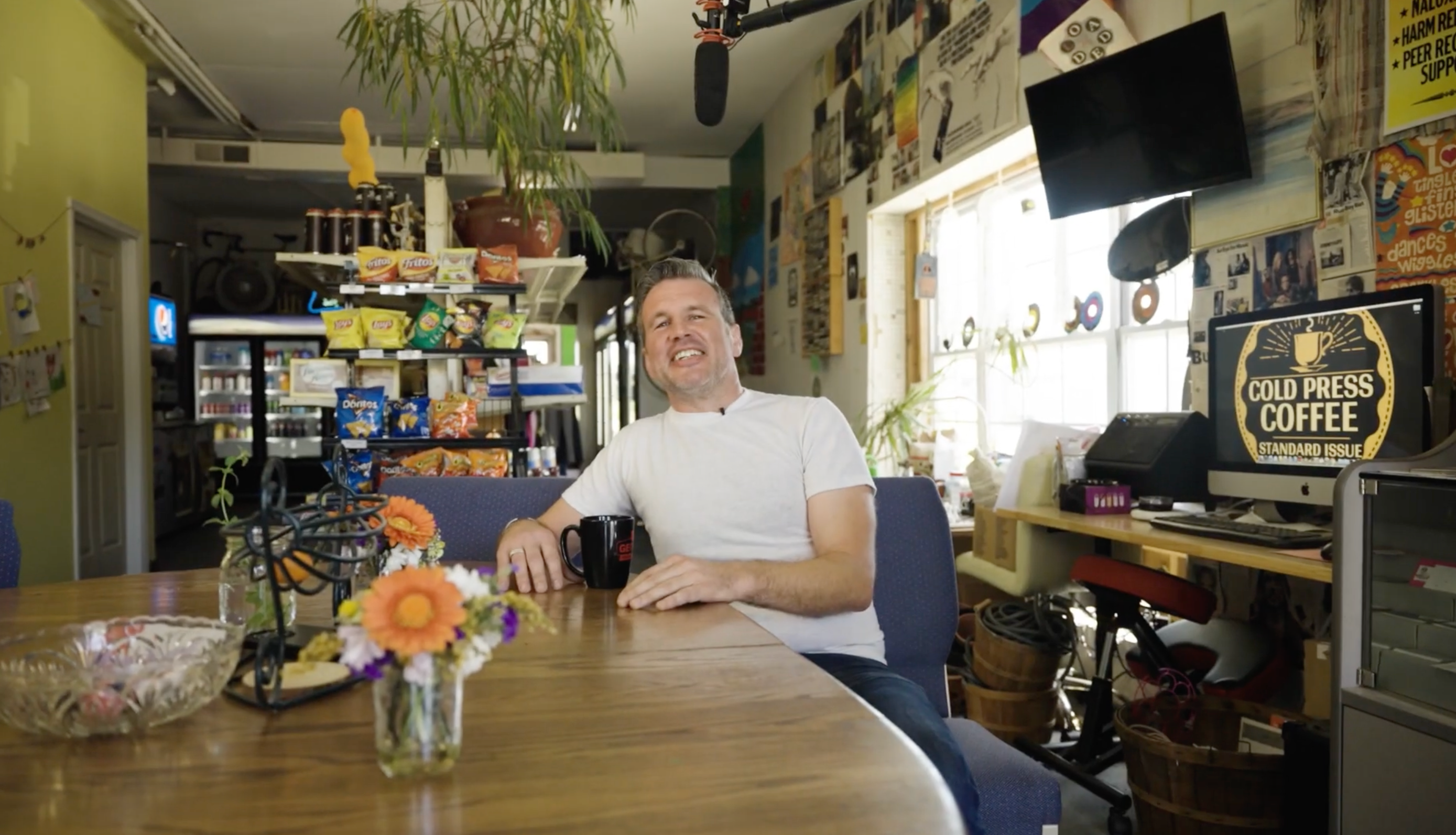 Mike Martin sitting in his shop, Common Market
