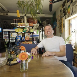 Mike Martin sitting in his shop, Common Market