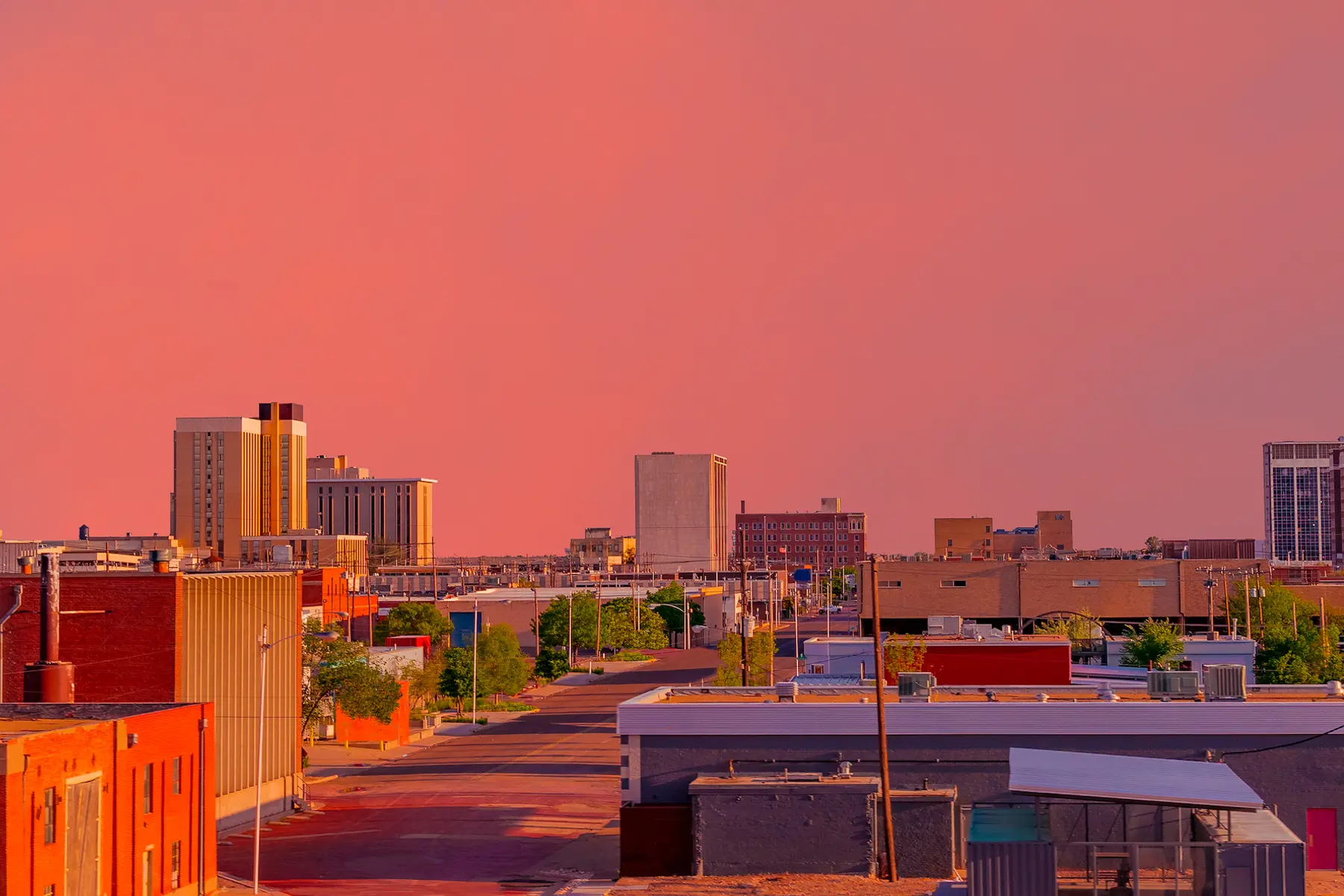Looking down at the downtown district with a brilliant sunset creating color everywhere in Lubbock, Texas.