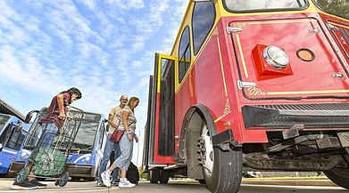 Crystal Craig (from right), Jimmy Craig and other passengers board a Fort Smith Transit shuttle, Wednesday, Sept. 11, 2024, at the transfer station in downtown Fort Smith. (River Valley Democrat-Gazette/Hank Layton)