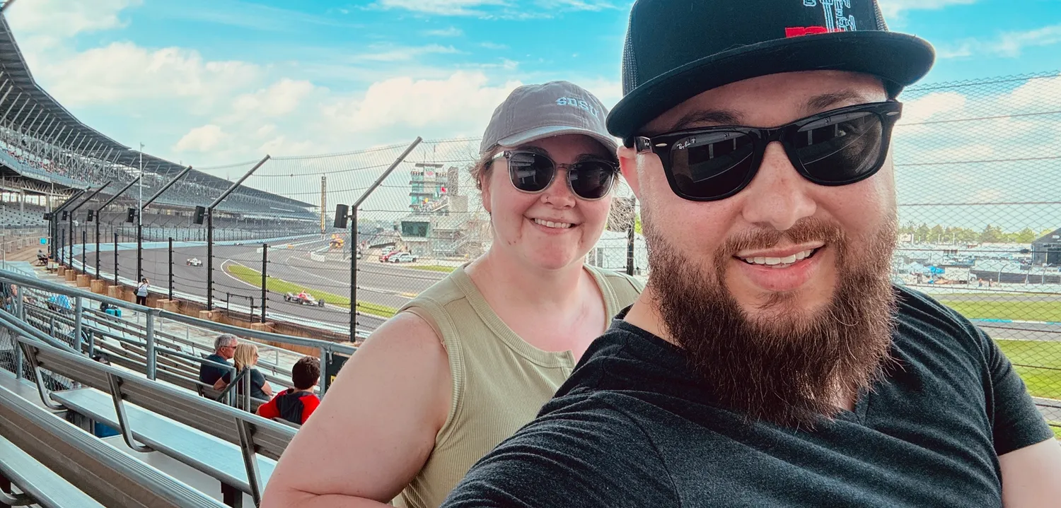 Movers Millie and Justin at the Indianapolis 500 with caption "Get Paid to Move to Indiana."