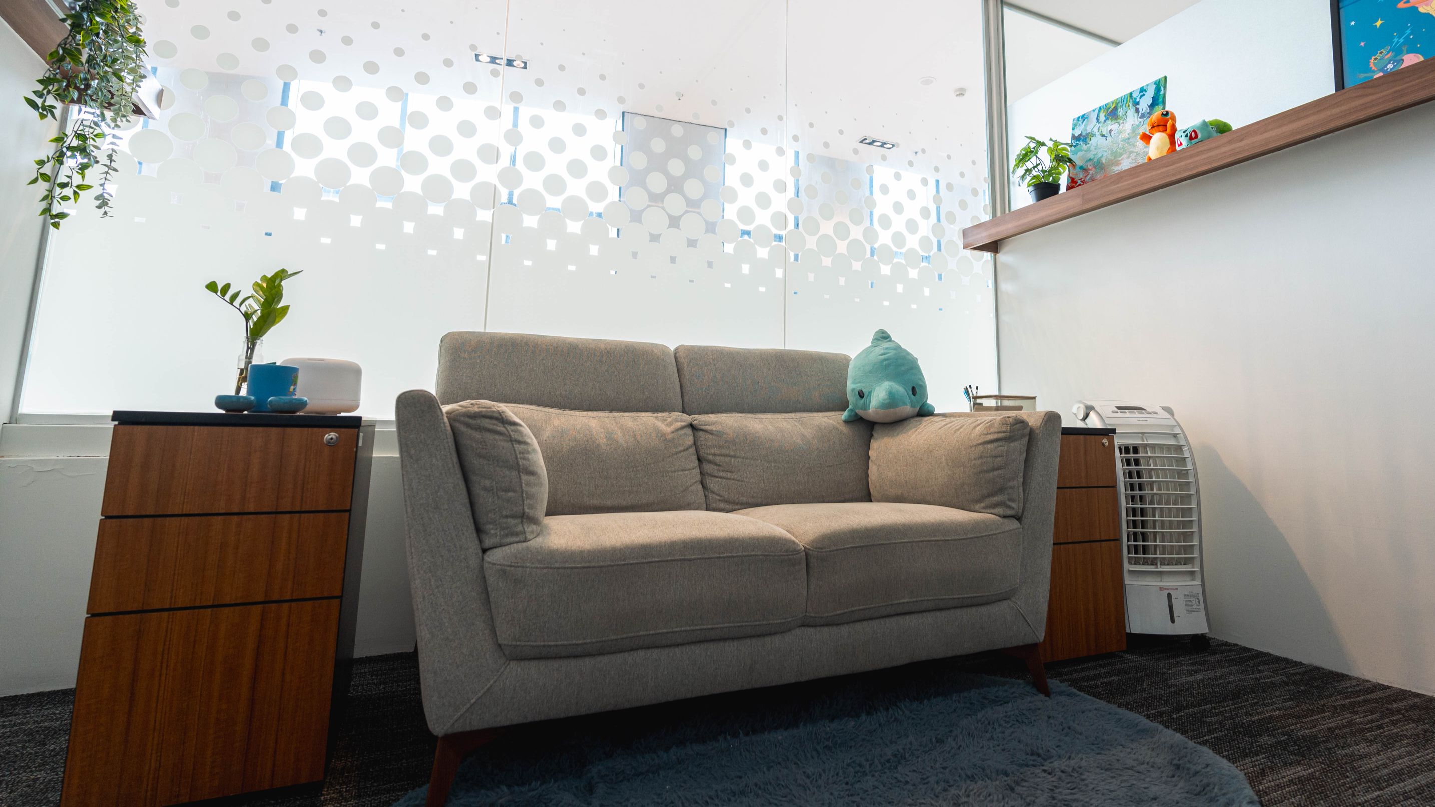 A quiet therapy room at Cara Cara IOI Mall Damansara with a sofa, a plant and soft lighting