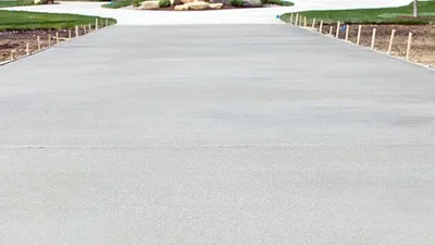 Ready-mix concrete being poured into slab forms at a residential construction site