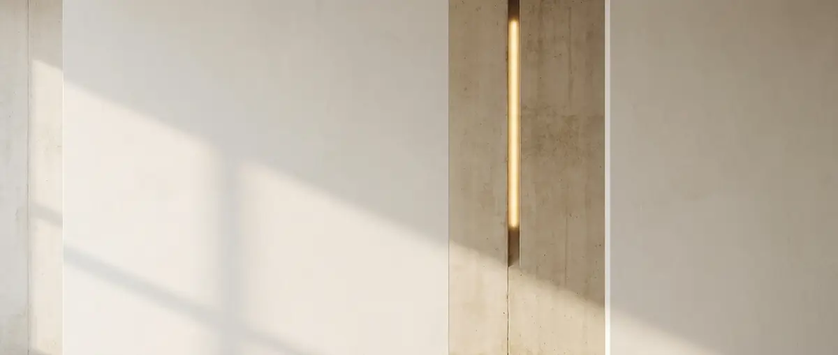 A bare plaster wall in raking daylight, a slim vertical recess lit warm gold