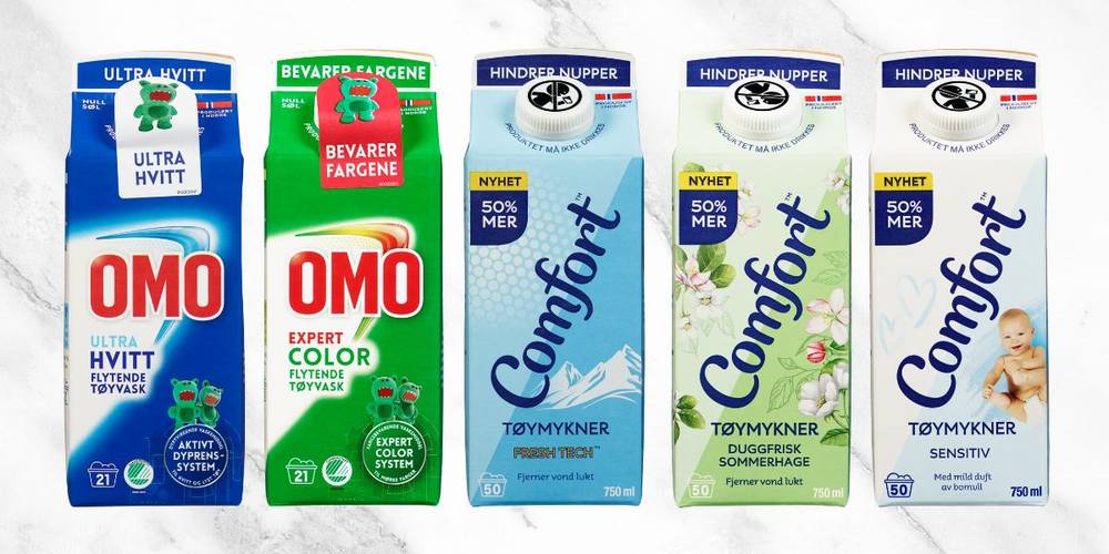 Produktbilder av OMO vaskemidler og Comfort tøymykner på marmorbakgrunn.
