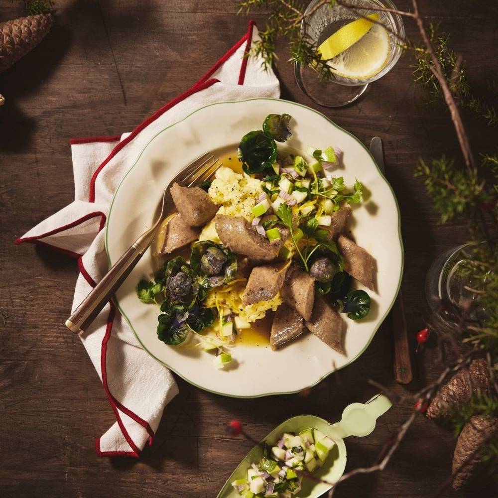 Tallerken med julepølse, potetstappe og rosenkål.