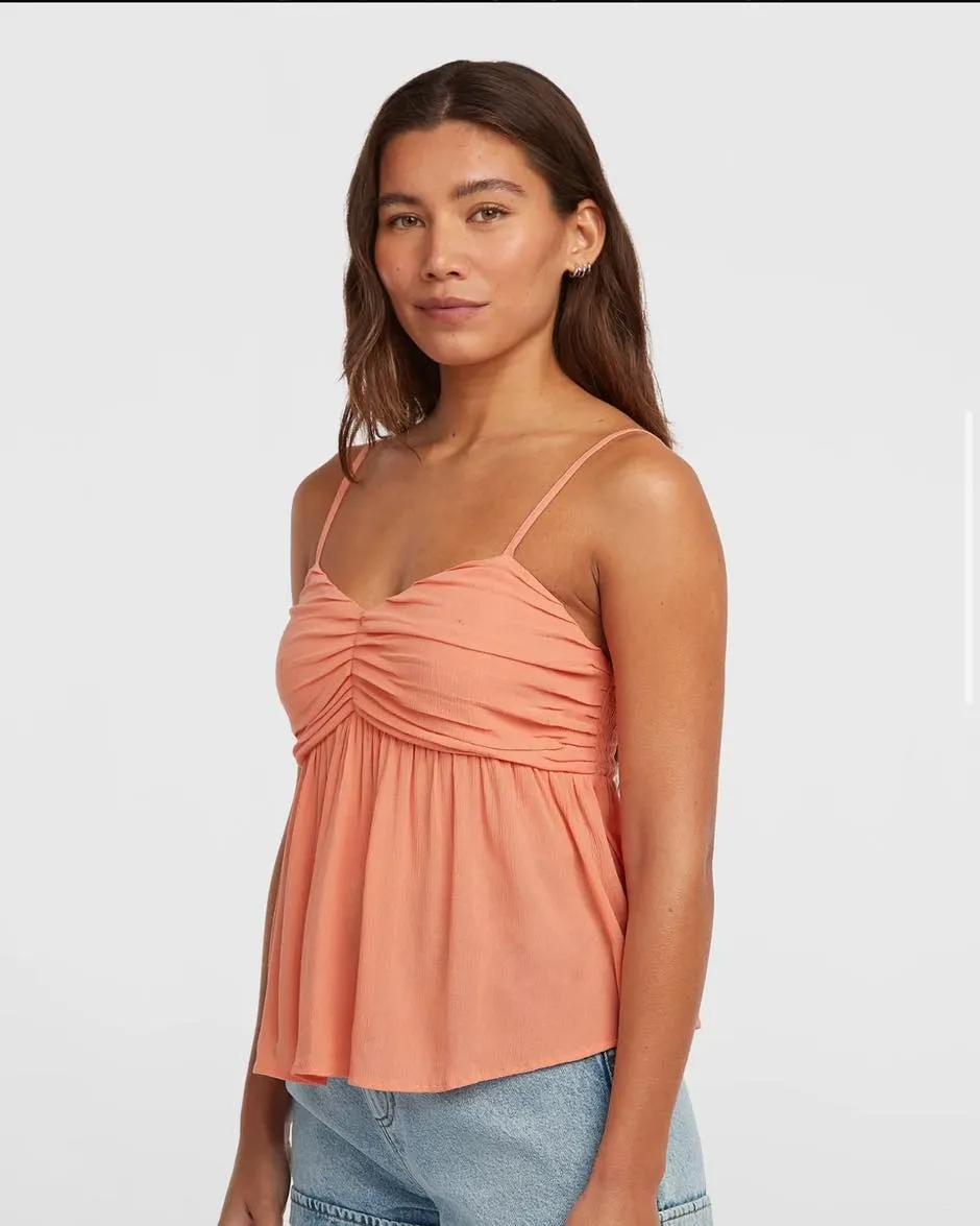 Girl in orange top smiling