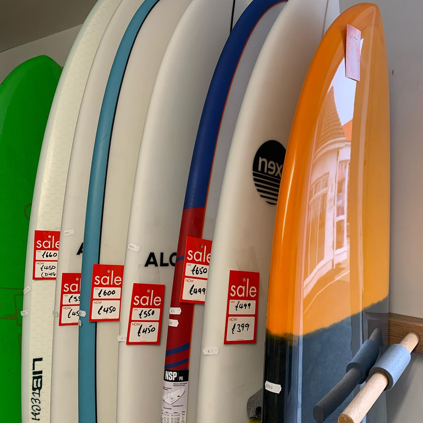Sale on multiple surfboards of different colours