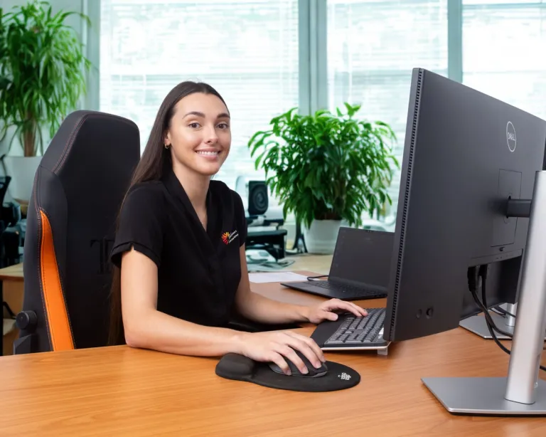 Woman smiling sitting at desk in office