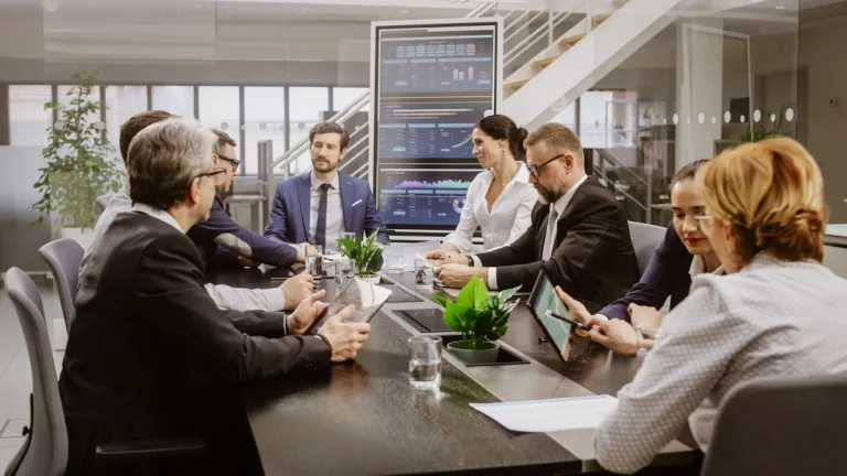 office staff sitting at meeting table