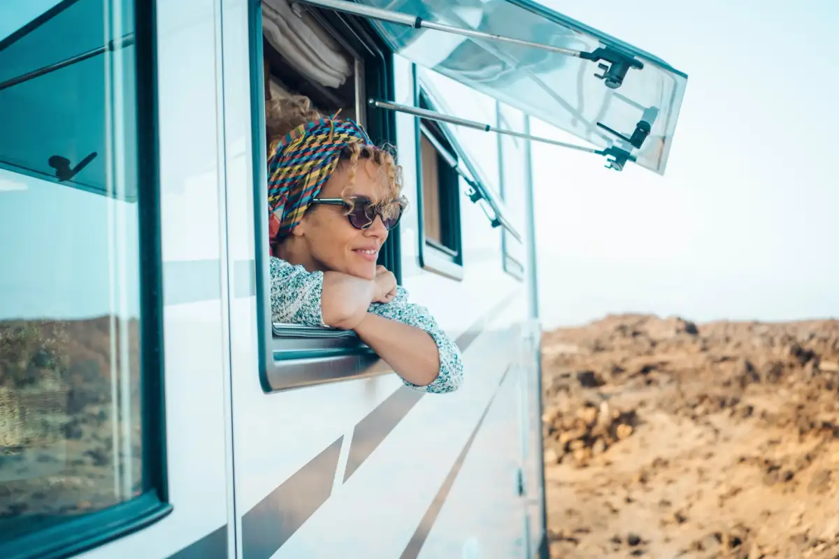 lady looking out window of caravan