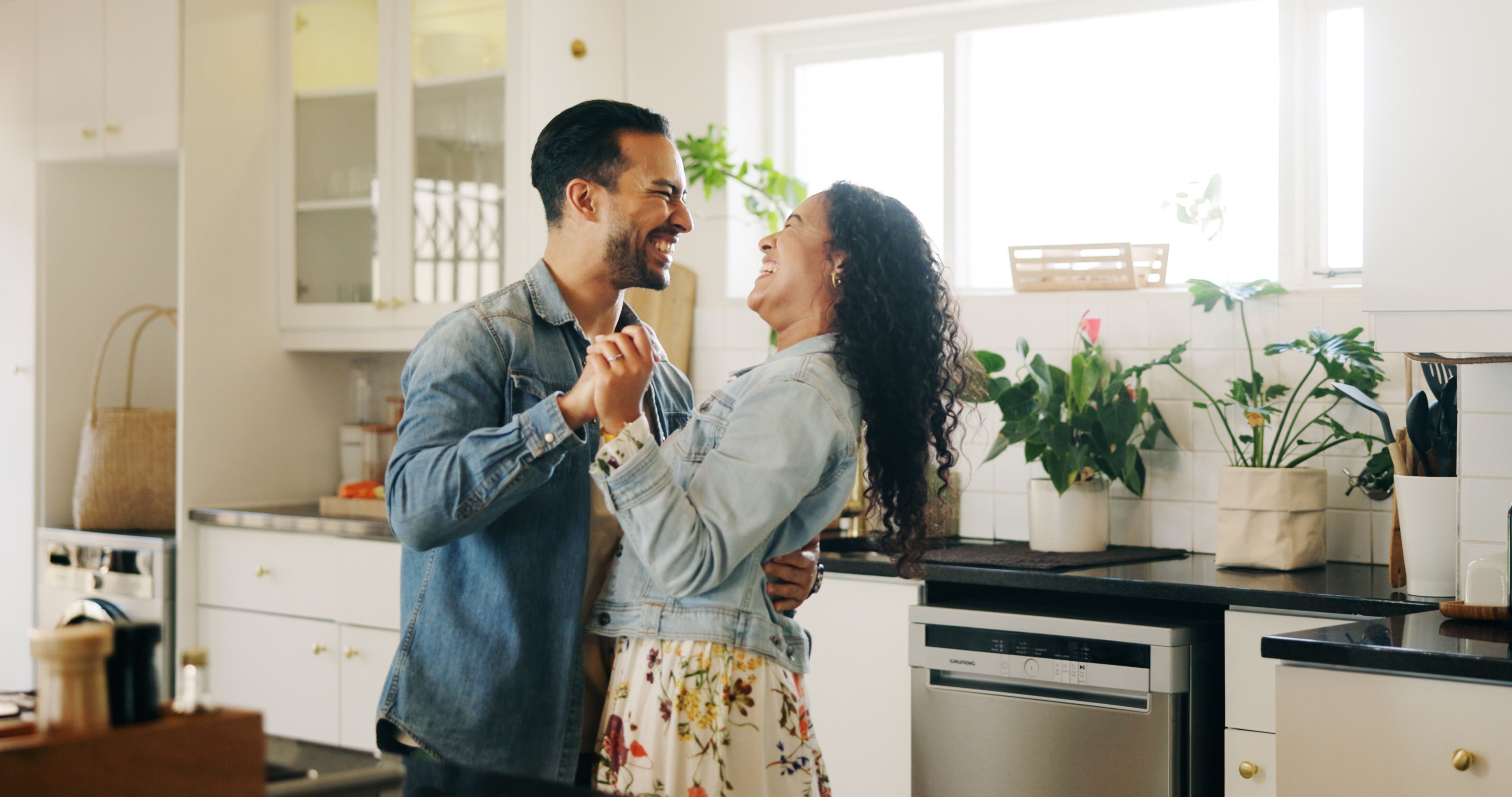 couple happy dancing in kitchen