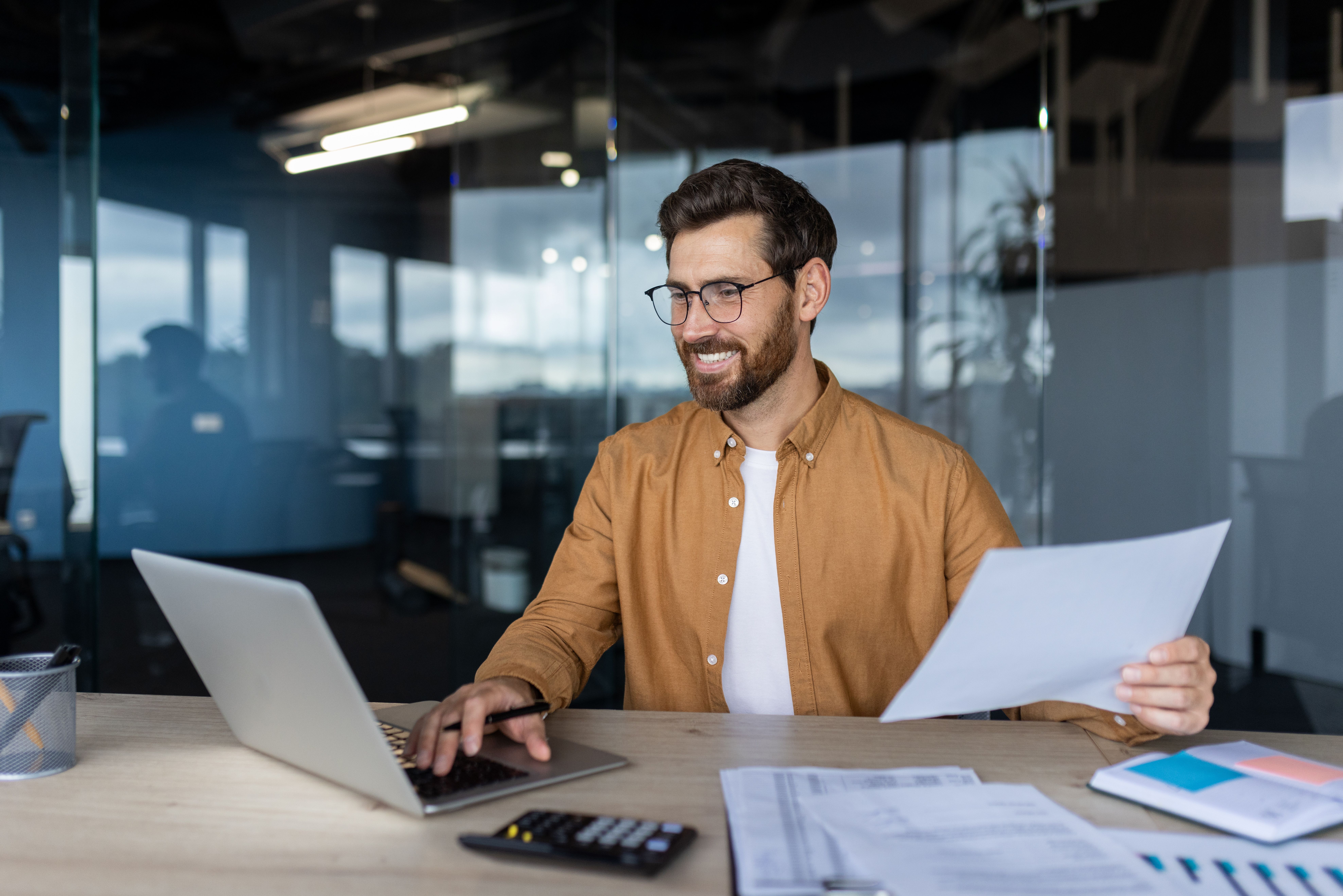 Man at office desk doing taxes