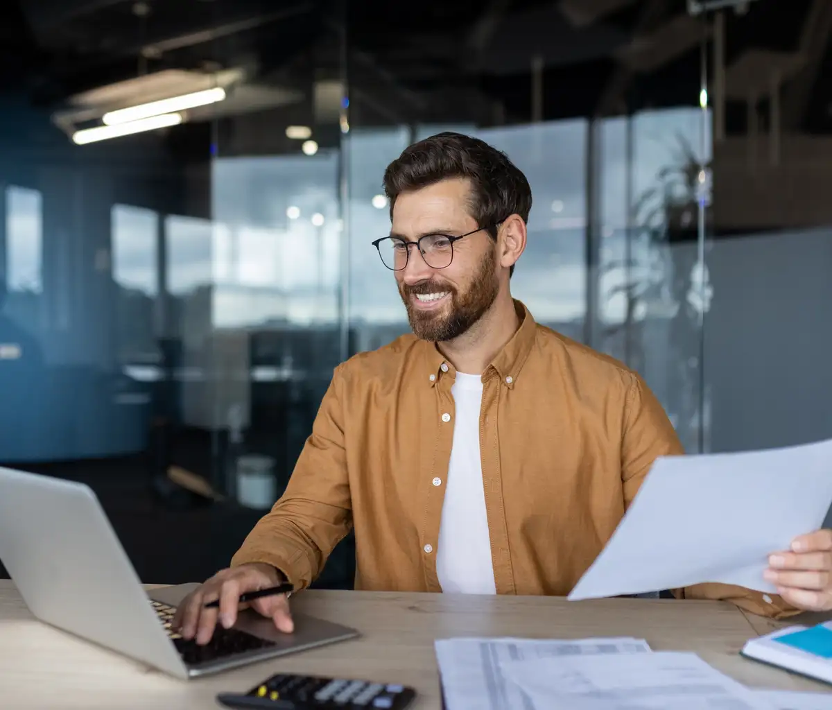 Man at office desk doing taxes