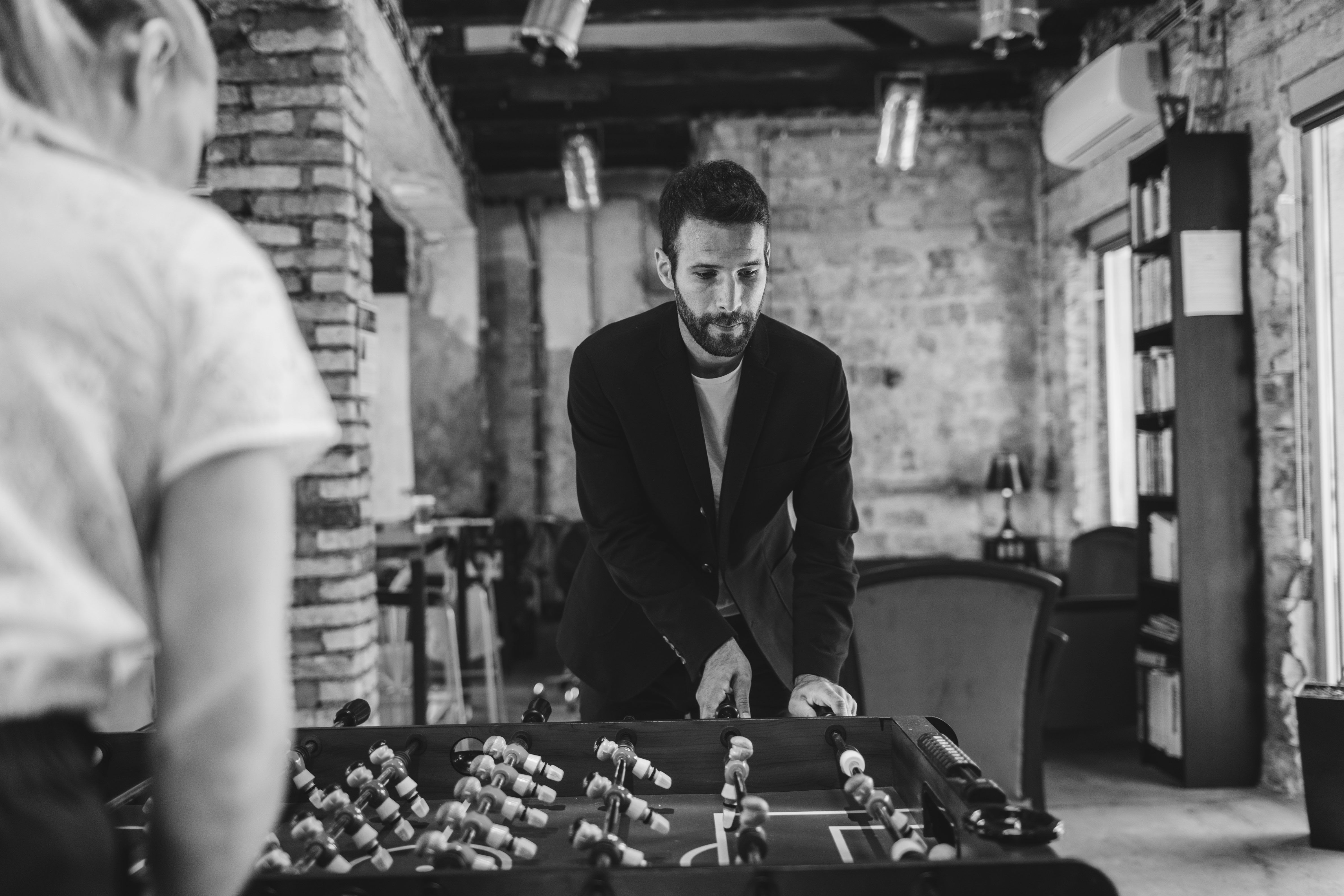 man playing table soccer at work