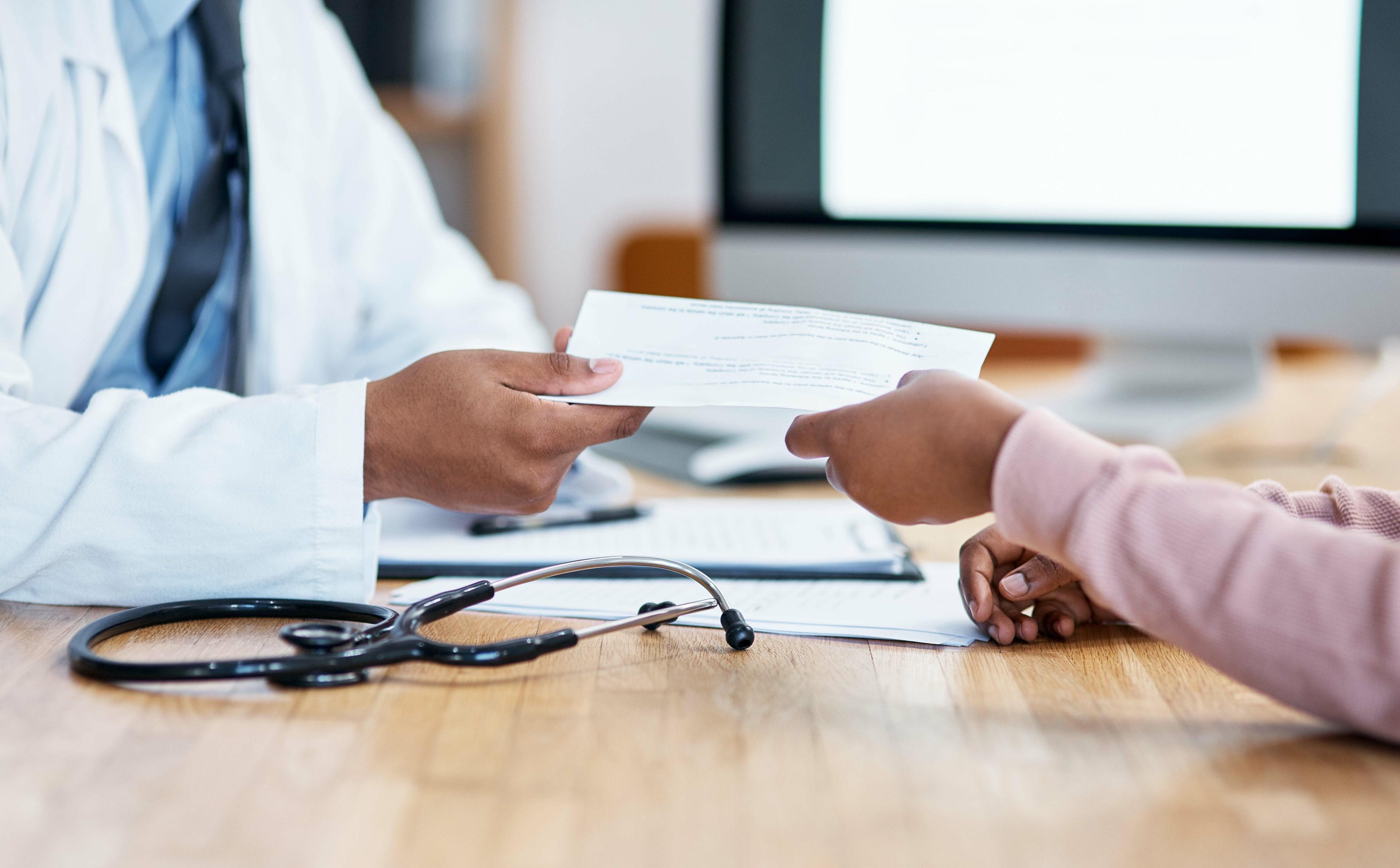 Healthcare professional writing a prescription