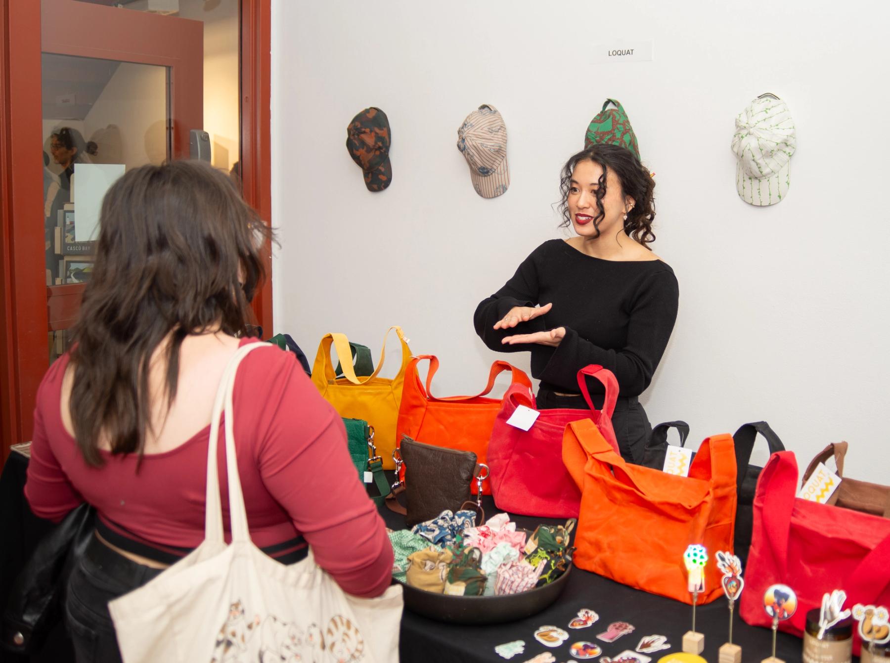 Loquat table during the holiday sale, with many brightly colored bags.