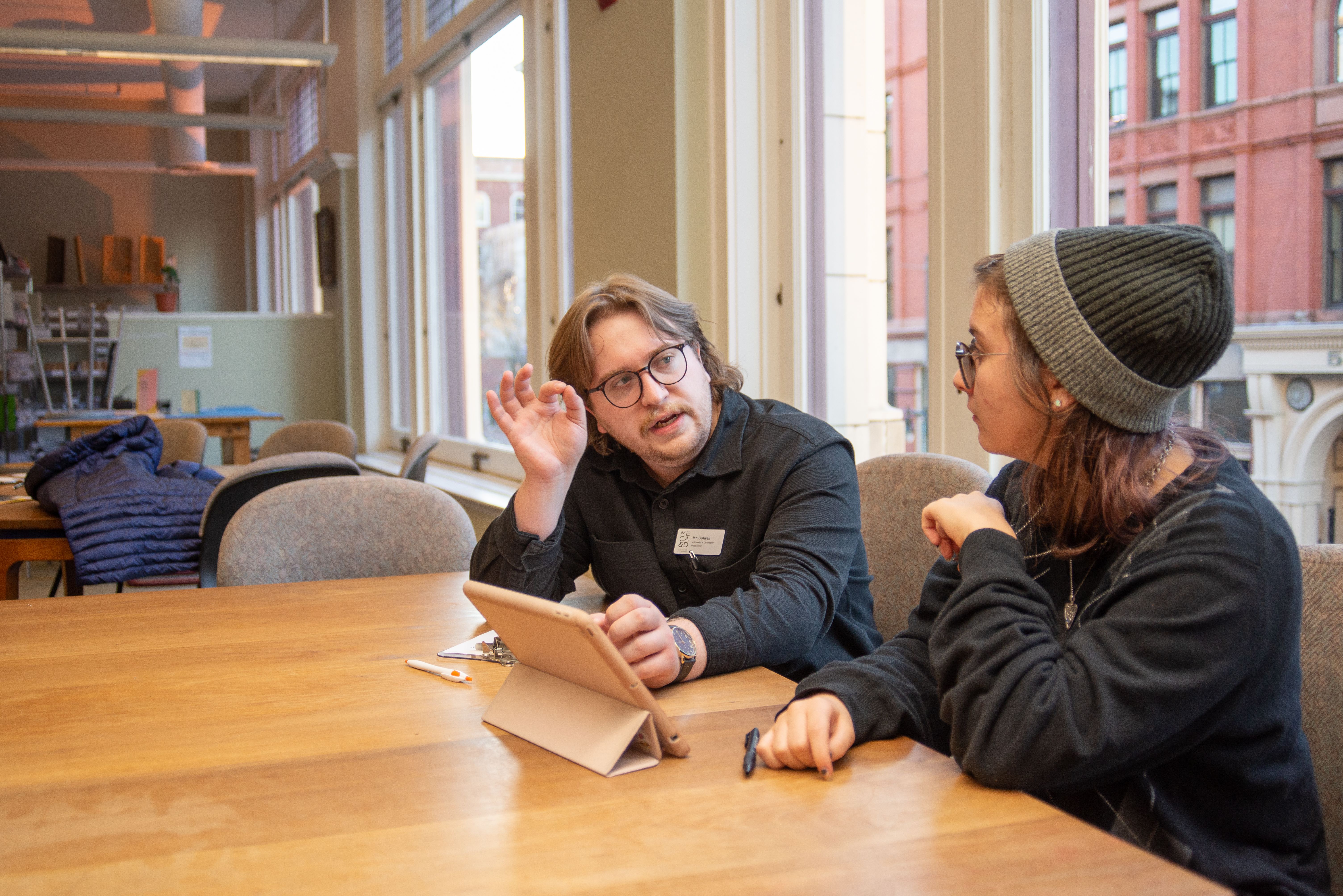 Visitor having a conversation during Open House.