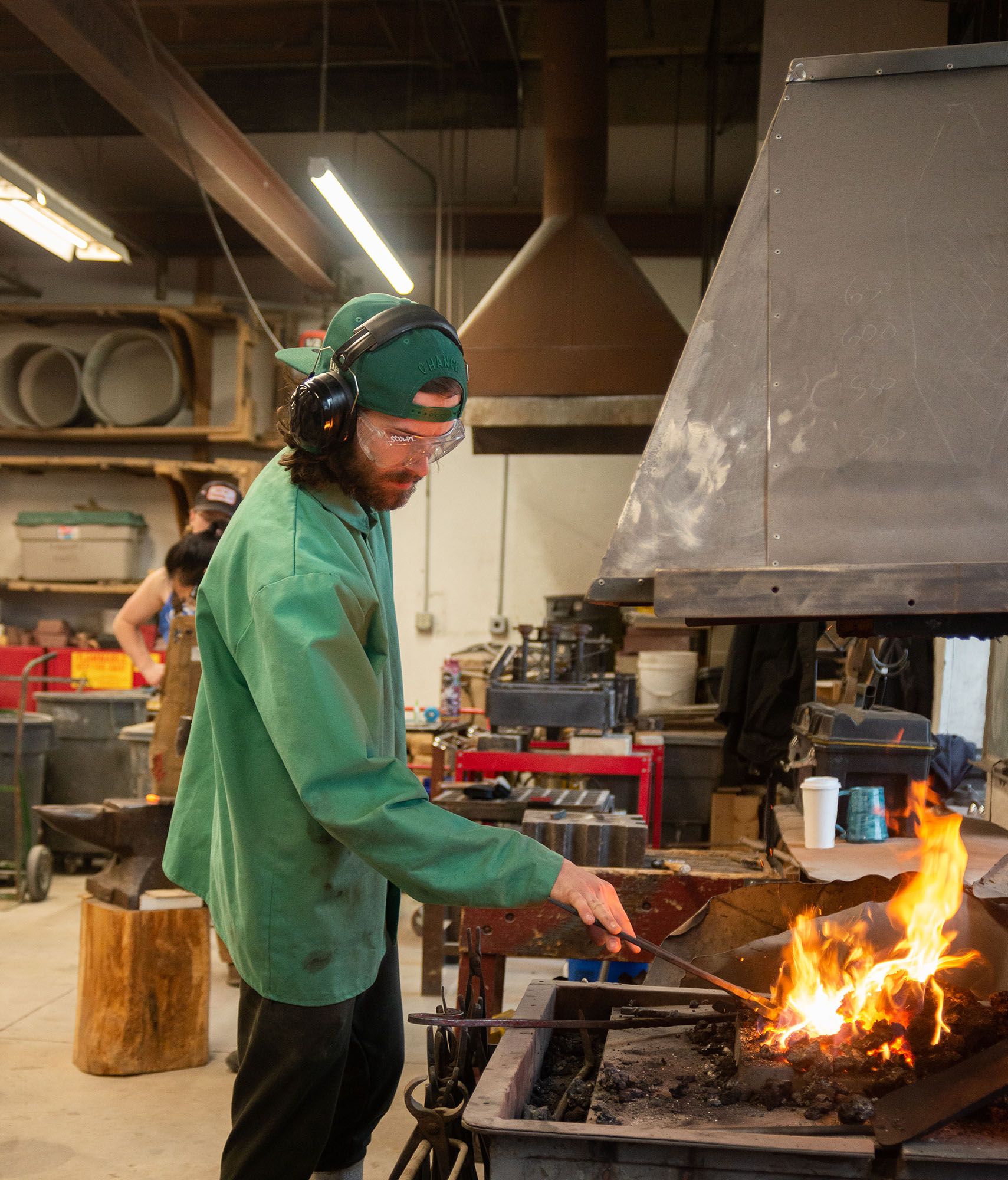 A student working on a blacksmith forge.