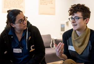 One person talking and one person listening thoughtfully.