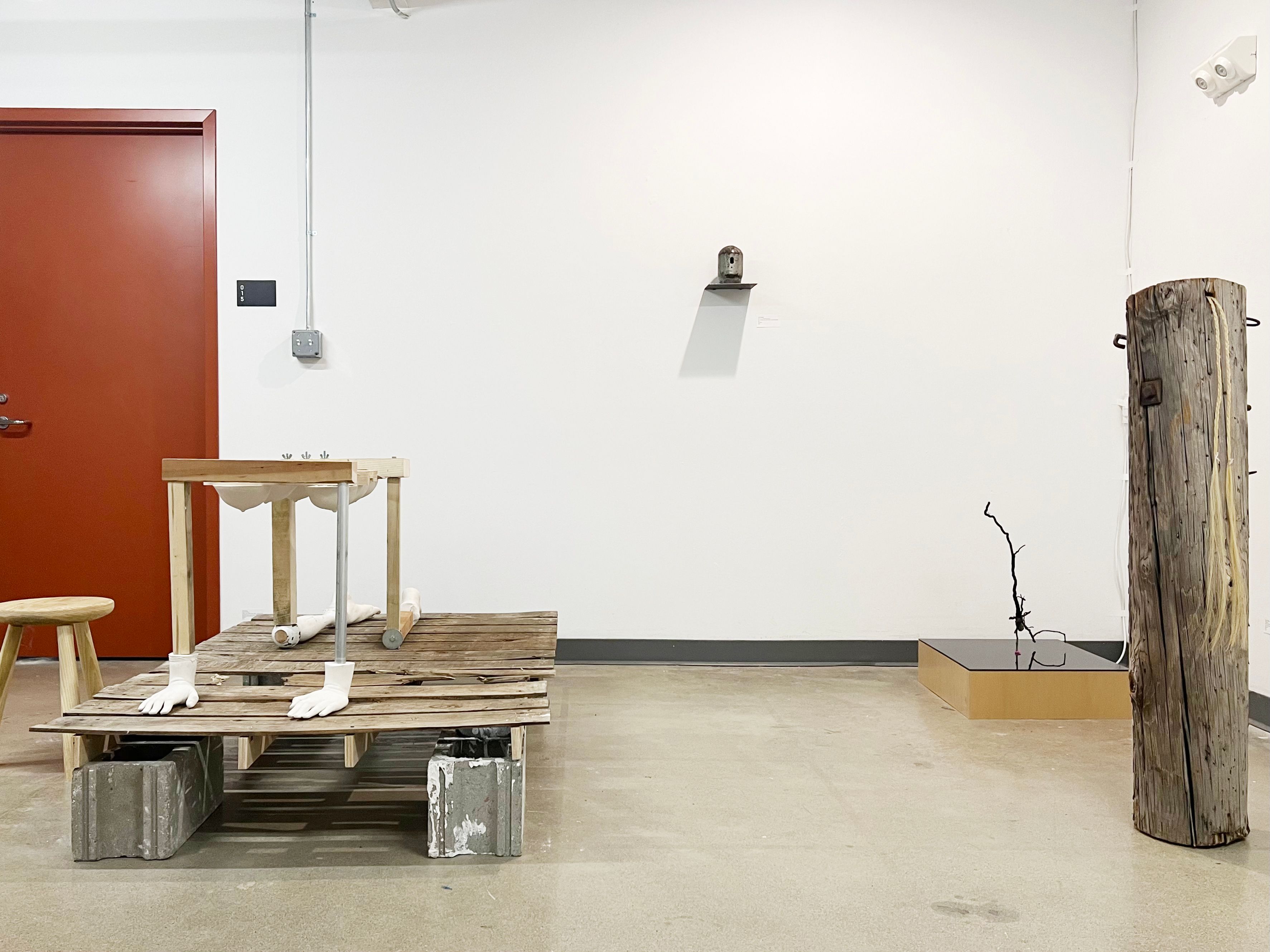 Installation view of a series of wooden, metal, and plaster sculptures.