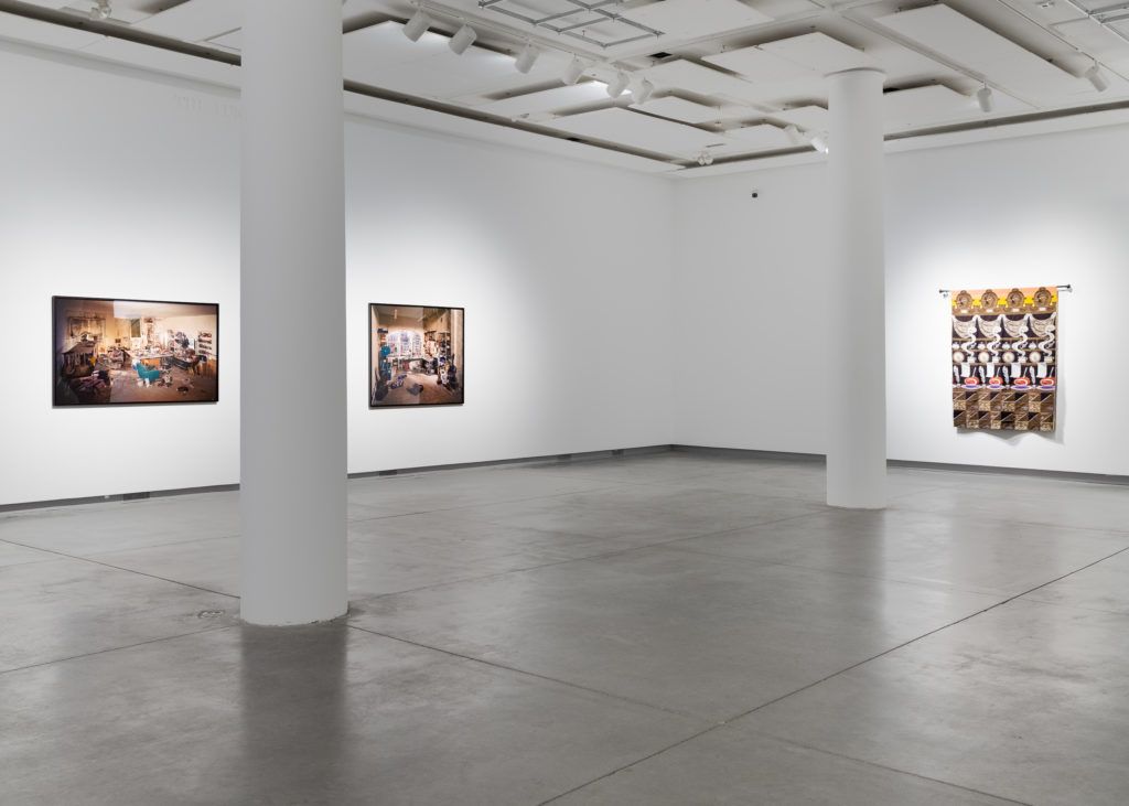 Gallery view of three large pieces on the white spacious walls.