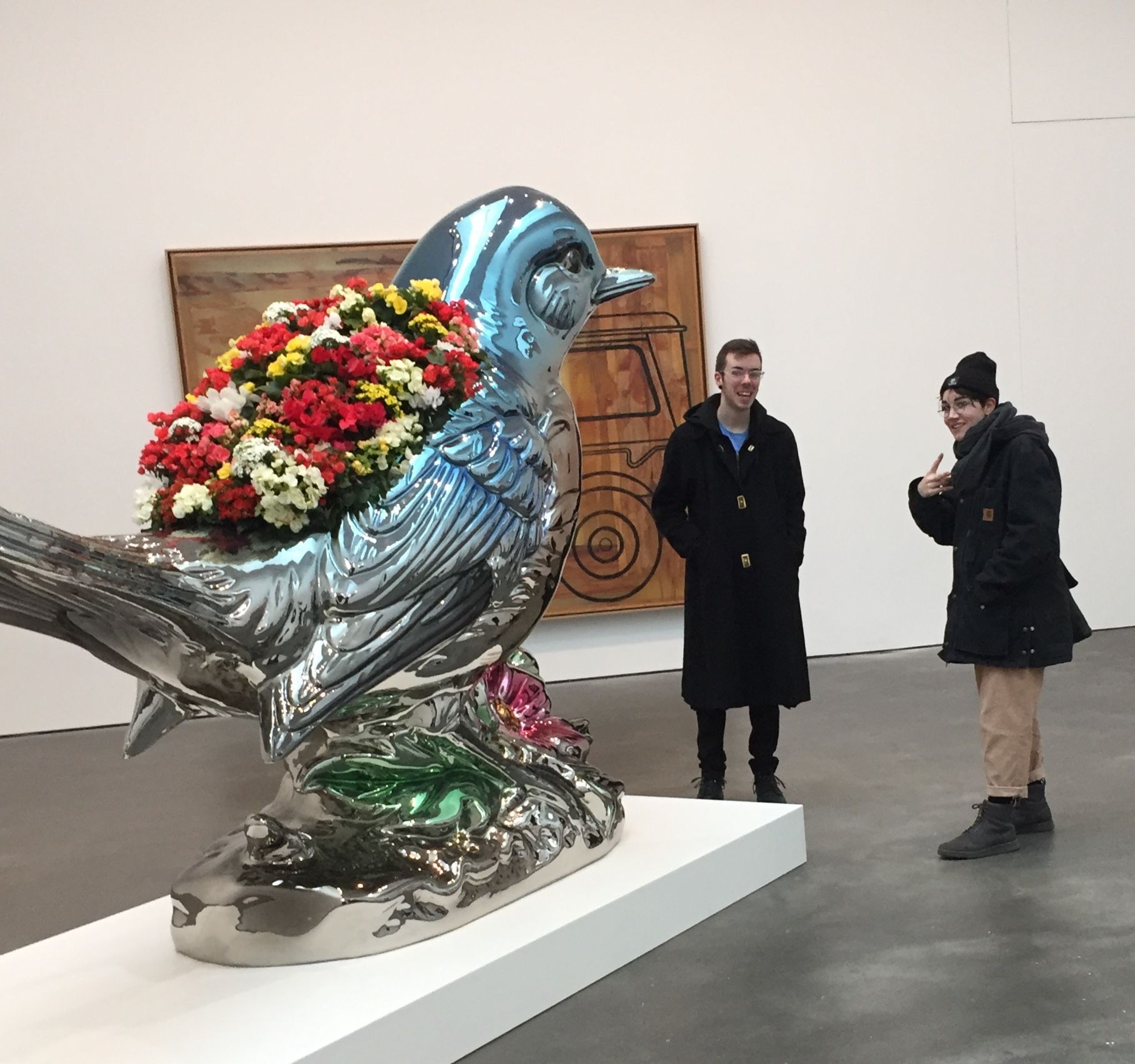 View of a Jeff Koons sculpture of a bird with flowers on its back.