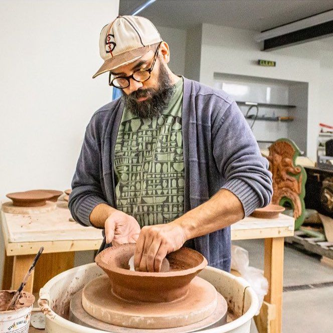 Jeremiah Ibarra working on a potter's wheel.