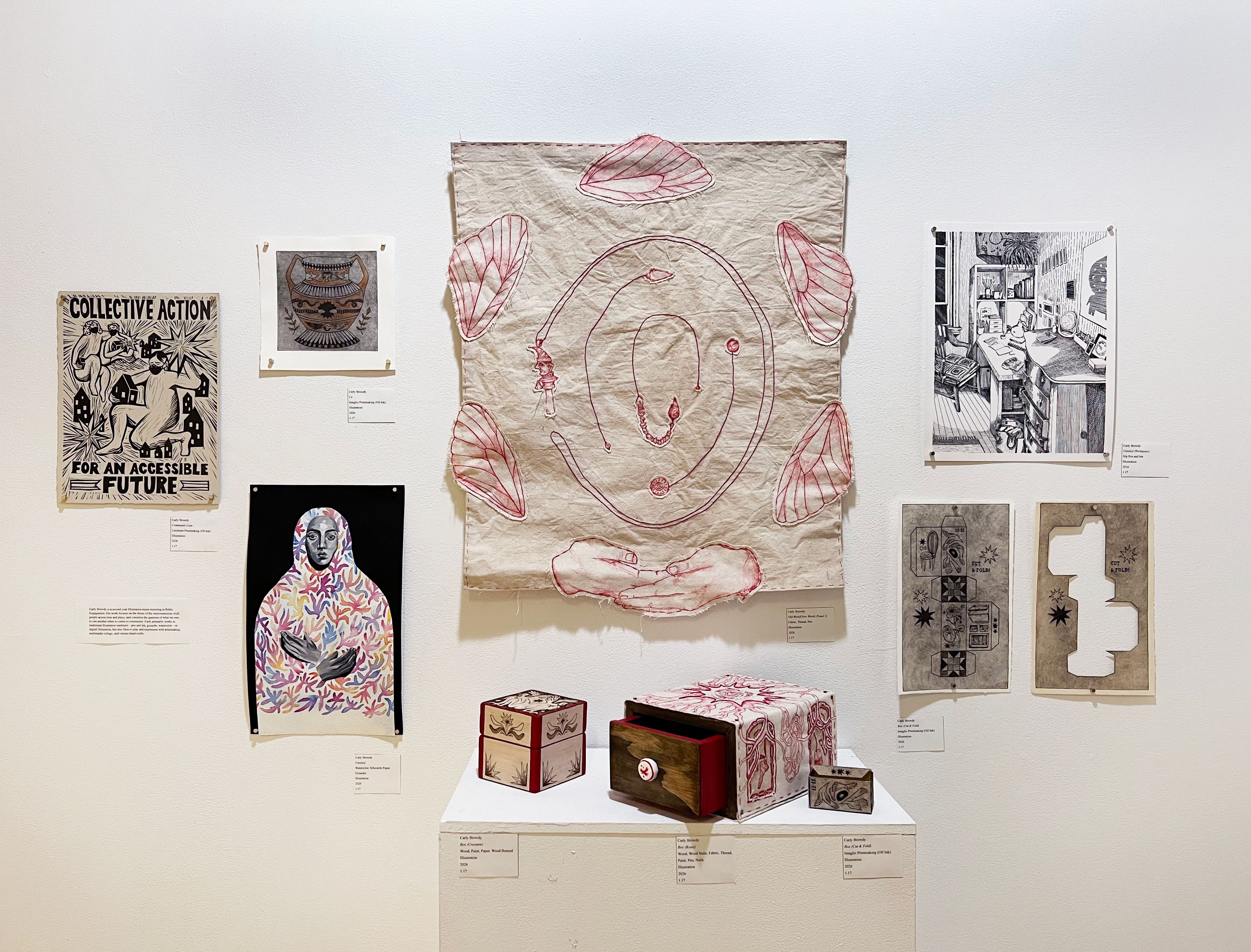 An installation of artwork including illustrations, an embroidered tapestry, and a wooden box.