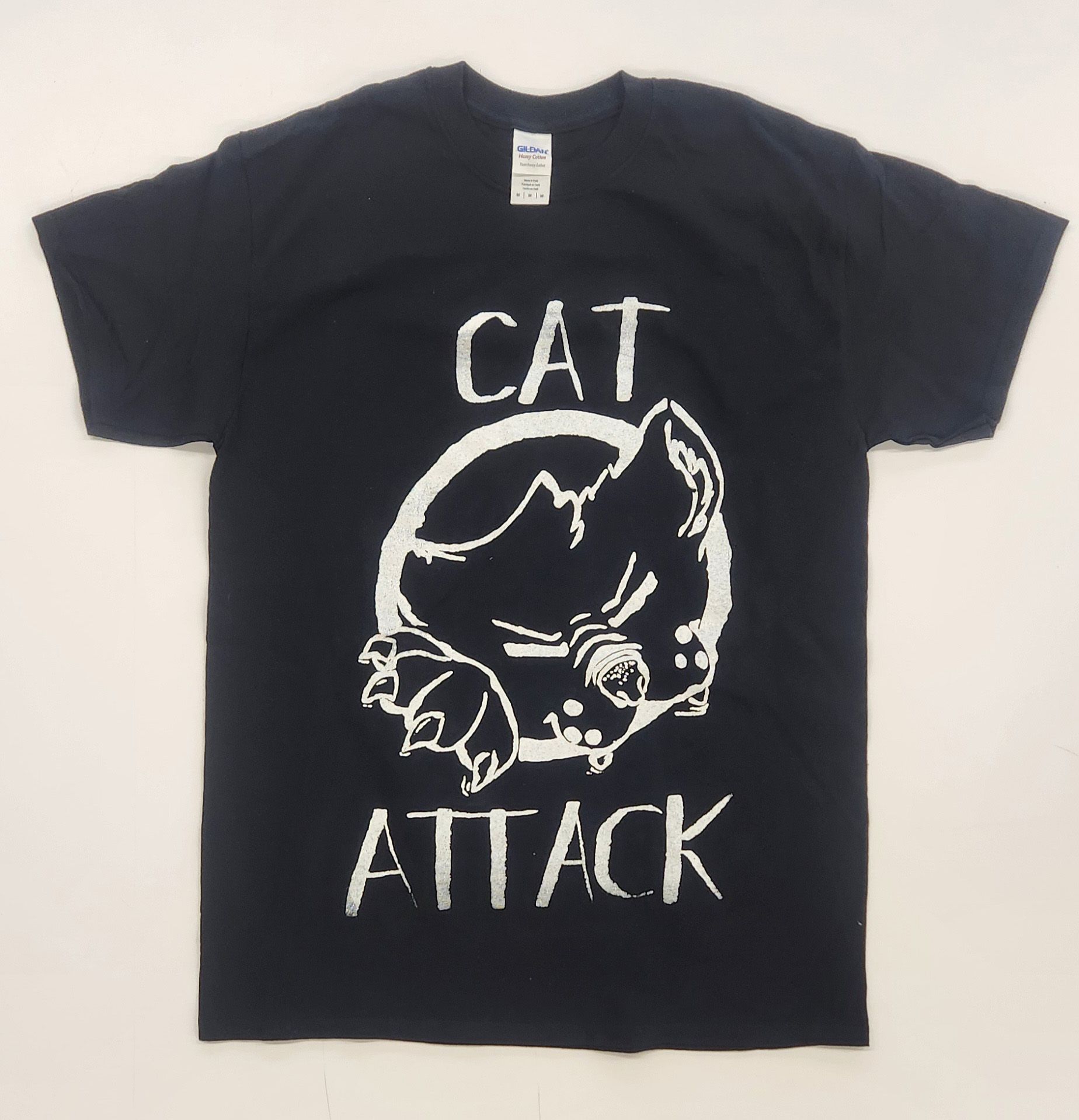 A black shirt with an illustration of a cat and the words, "Cat Attack"