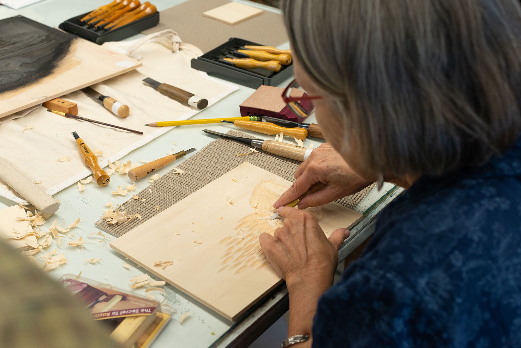 Visiting artist, April Vollmer, carving a woodcut.